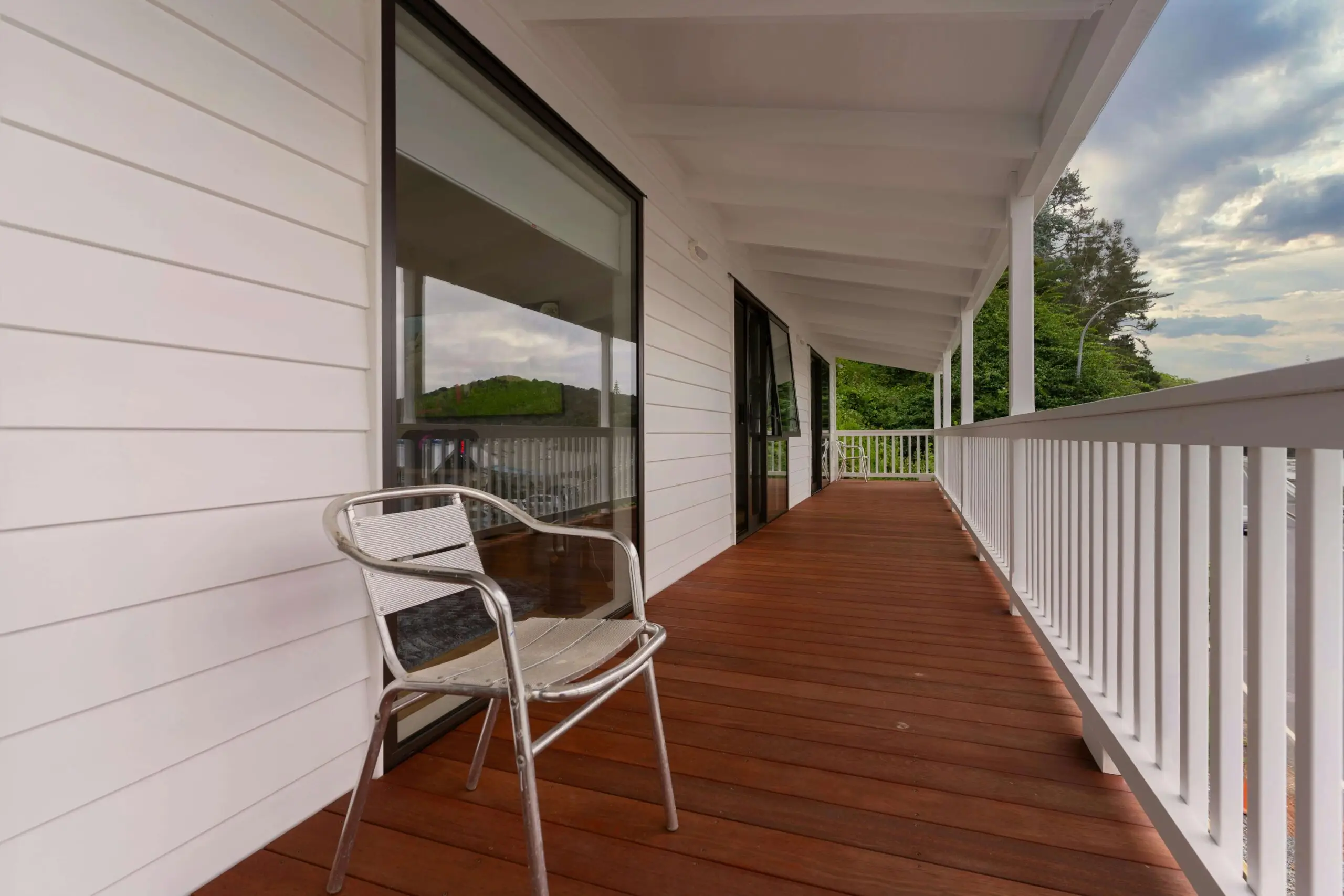 chair on a long wooden porch outside